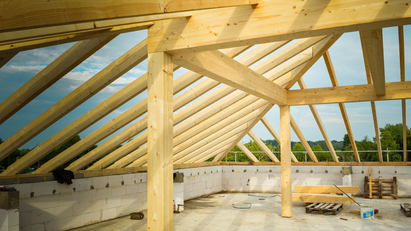New hip roof rafters landing on the wall plate before sheathing, the eave line where a baffle goes in every bay